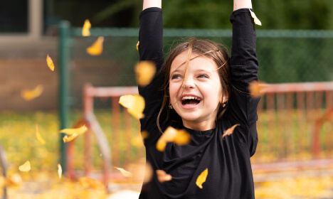 Girl in Autumn Leaves