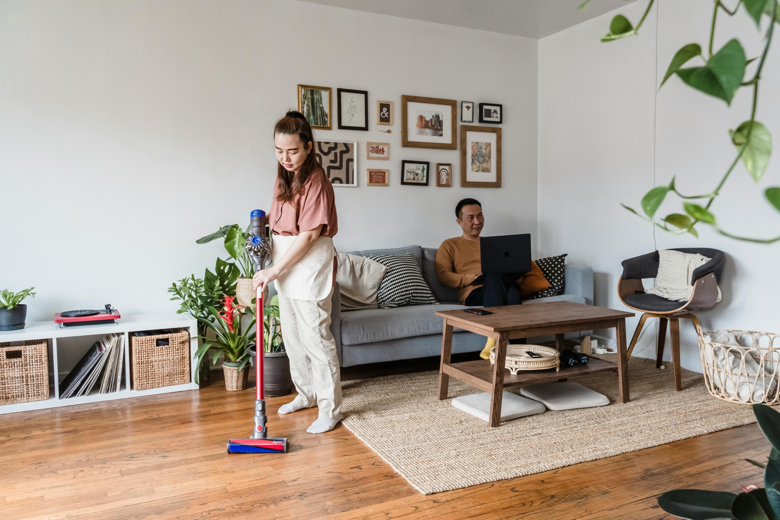 Woman vacuuming to remove dust mites and reduce allergy symptoms